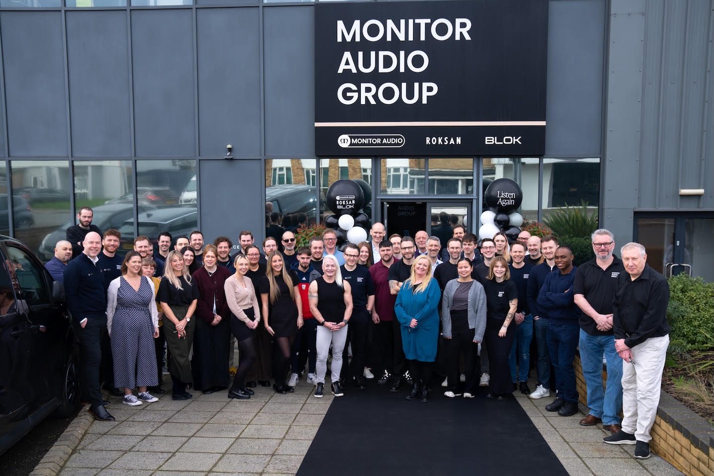 The Monitor Audio Group team outside the company's headquarters